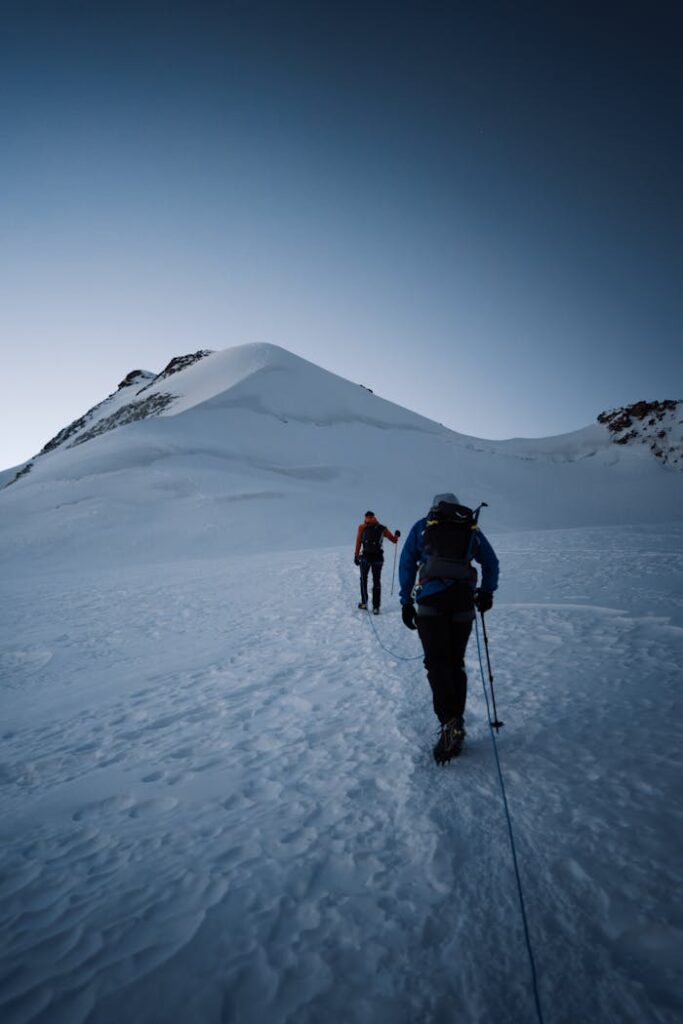 pexels photo 18325099 Two mountaineers trek a snow-covered mountain, showcasing winter adventure and perseverance.